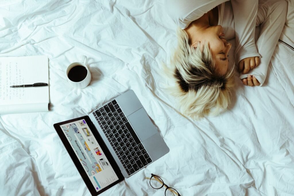 young woman using laptop in bed and resting