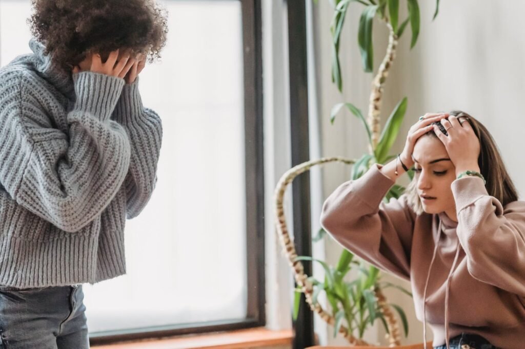 unrecognizable woman having argument with upset female