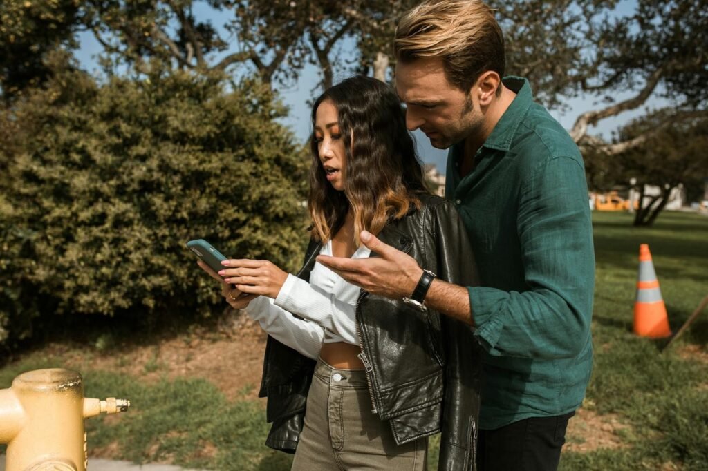 a couple looking at mobile phone while having an argument