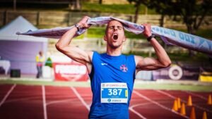 man ripping finish line strap