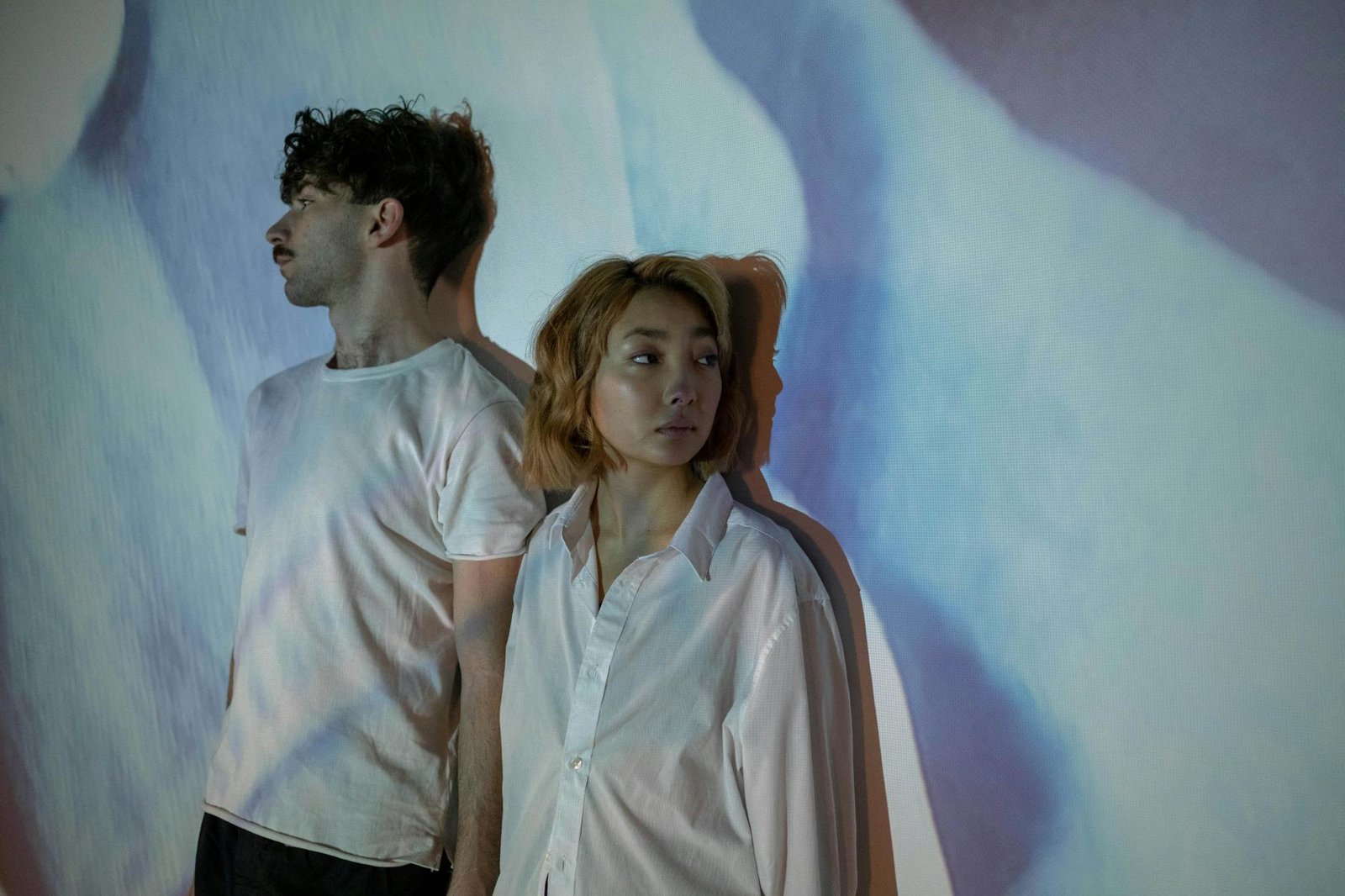 a sad couple wearing white shirts