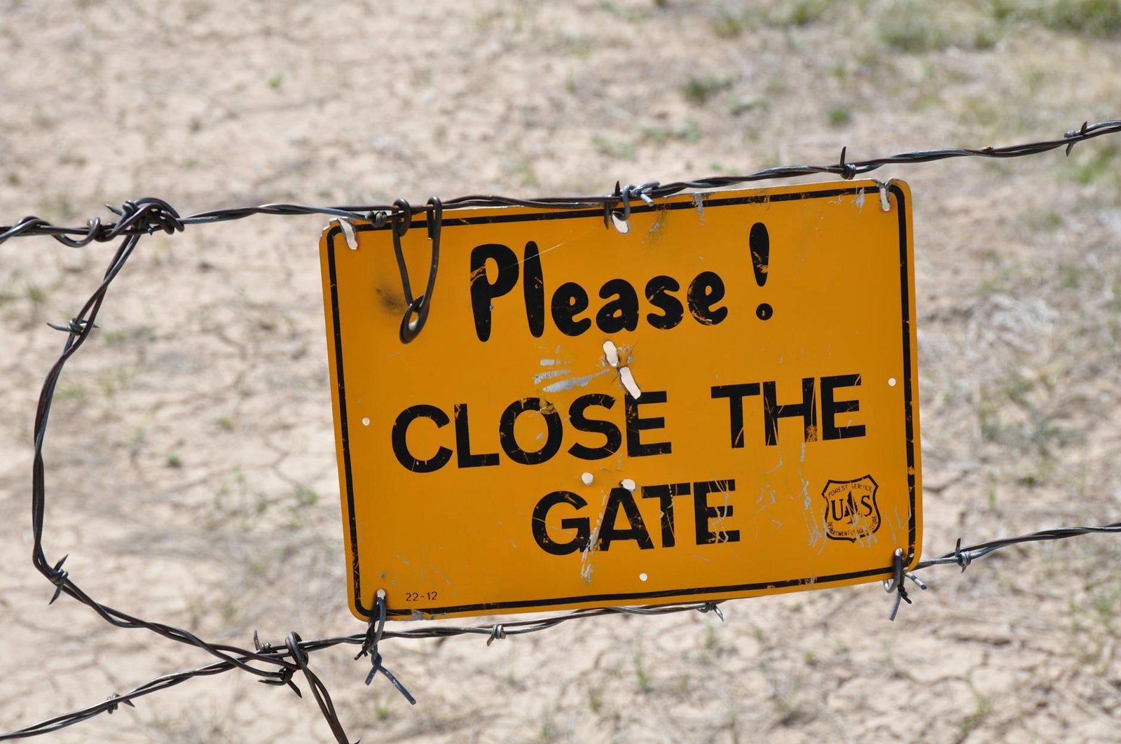 sign on barbed wire